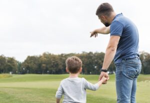 father-son-holding-hands-from-shot